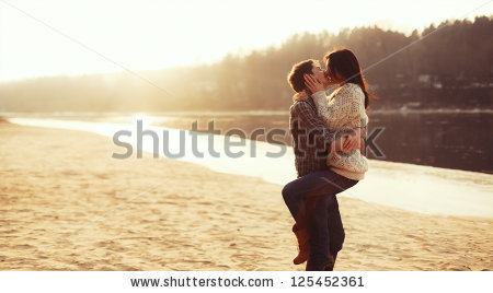 stock-photo-young-beautiful-couple-in-love-staying-and-kissing-on-the-beach-on-sunset-soft-sunny-colors-125452361